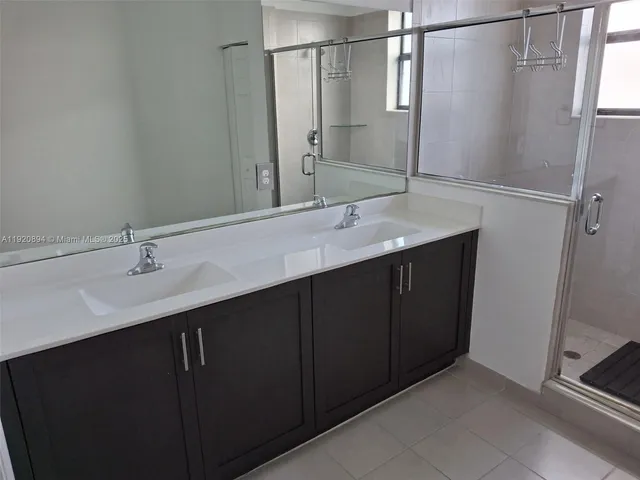 a bathroom with a double vanity sink and mirror