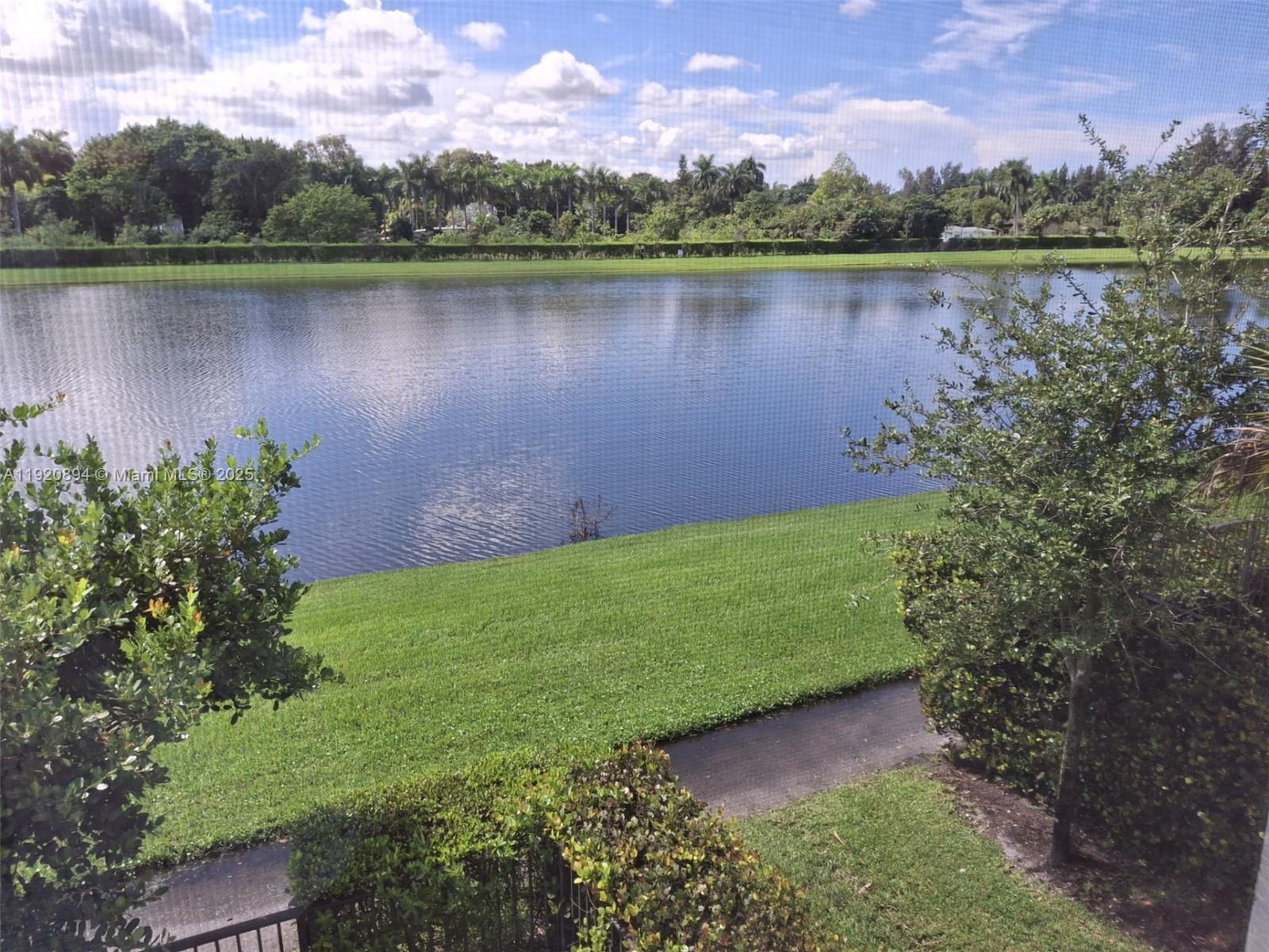 5896 Mustang Manor Davie, FL 33314 - Photo 5 of 14 a view of a lake with a house in the background