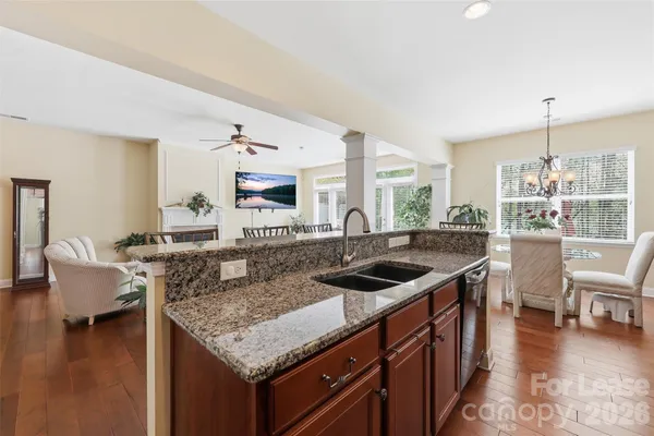a kitchen with granite countertop a sink and a stove