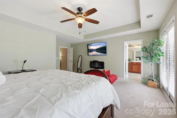 a bed room with a bed and a chandelier