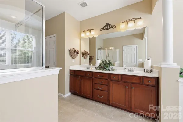 a spacious bathroom with a double vanity sink mirror and double