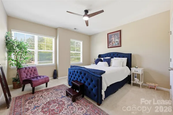 a bedroom with a bed chair and a window