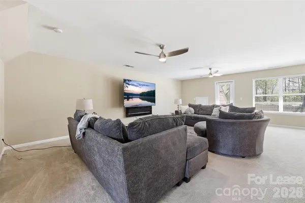a living room with couches and a flat screen tv