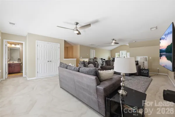 a living room with furniture and a ceiling fan
