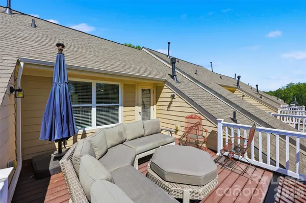 a view of a balcony with chair and wooden floor