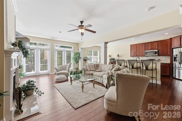 a living room with furniture wooden floor and a chandelier