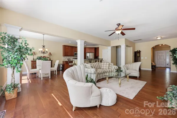 a living room with furniture or wooden floor and a chandelier