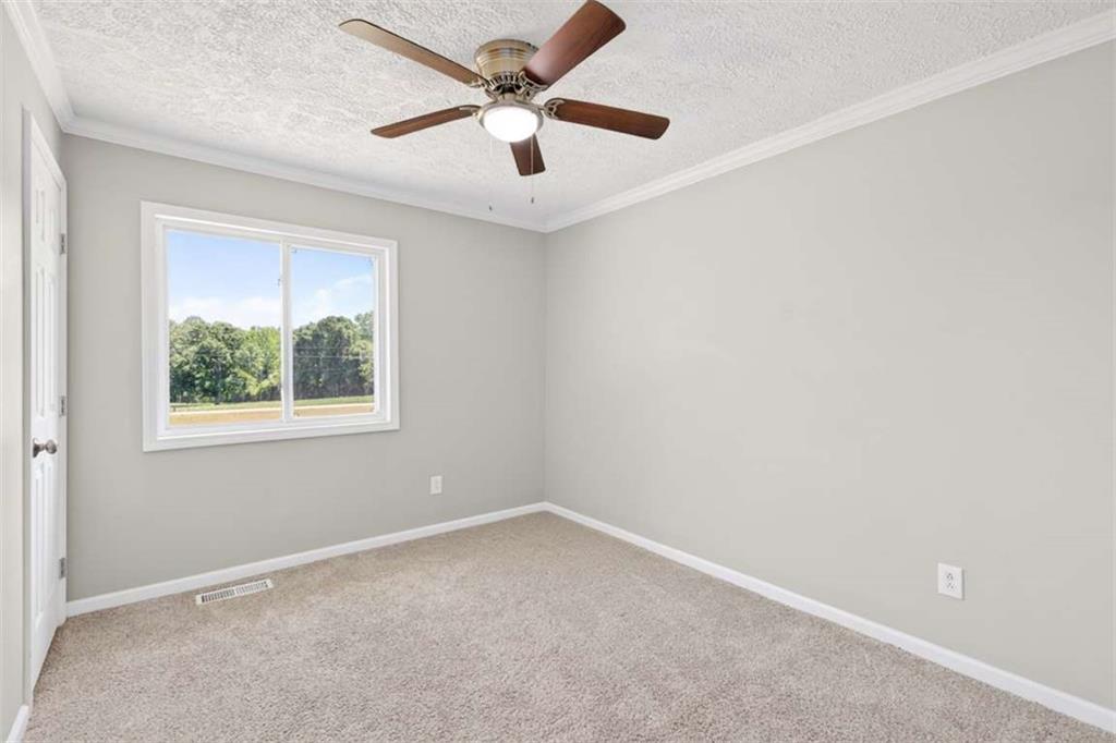 3696 Crabapple Hollow Road Nicholson, GA 30565 - Photo 16 of 38 an empty room with a window and a fan