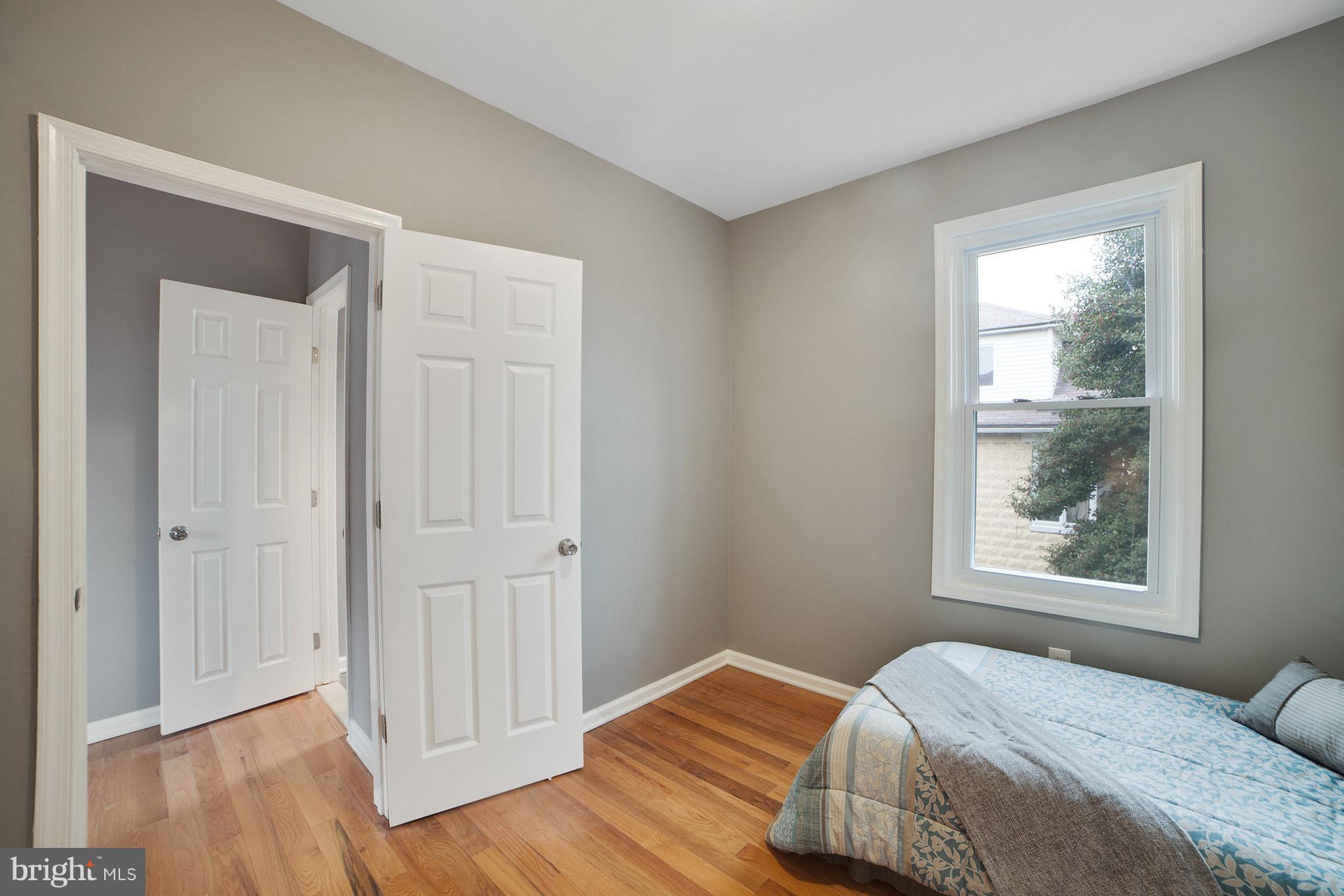 114 West Edgevale Road Baltimore, MD 21225 - Photo 13 of 22 a bedroom with a bed and a window