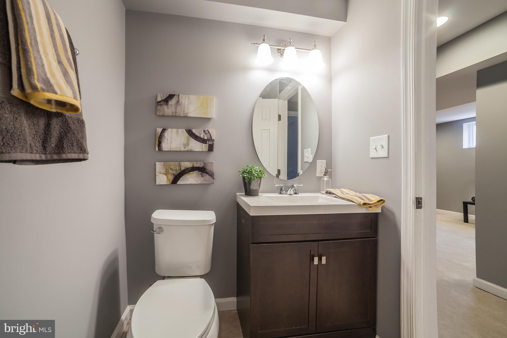 114 West Edgevale Road Baltimore, MD 21225 - Photo 21 of 22 a bathroom with a toilet a sink and mirror