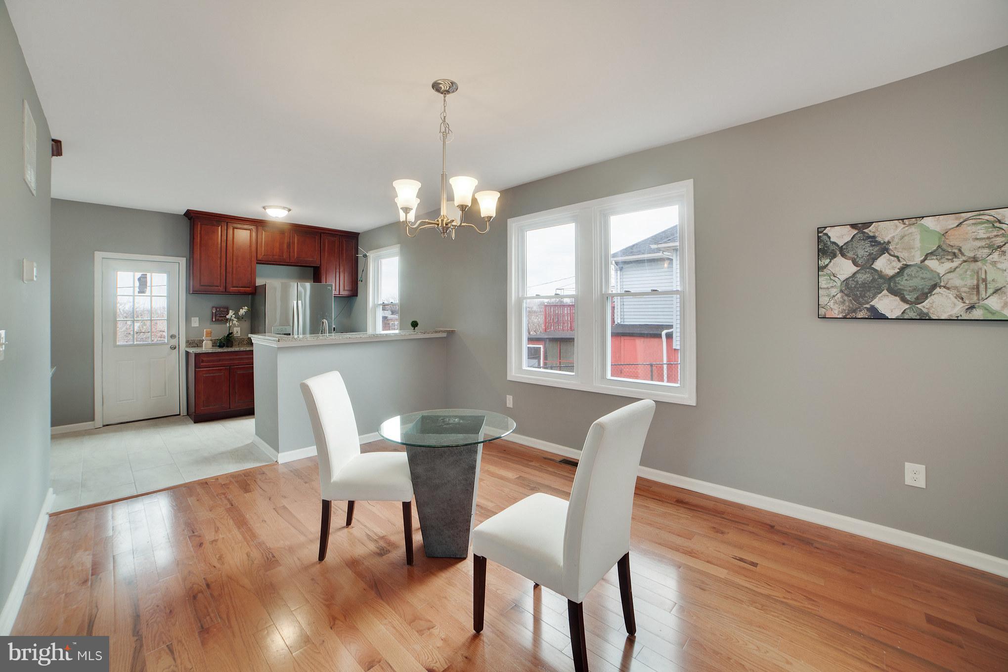 114 West Edgevale Road Baltimore, MD 21225 - Photo 6 of 22 a view of a dining room with furniture wooden floor and chandelier