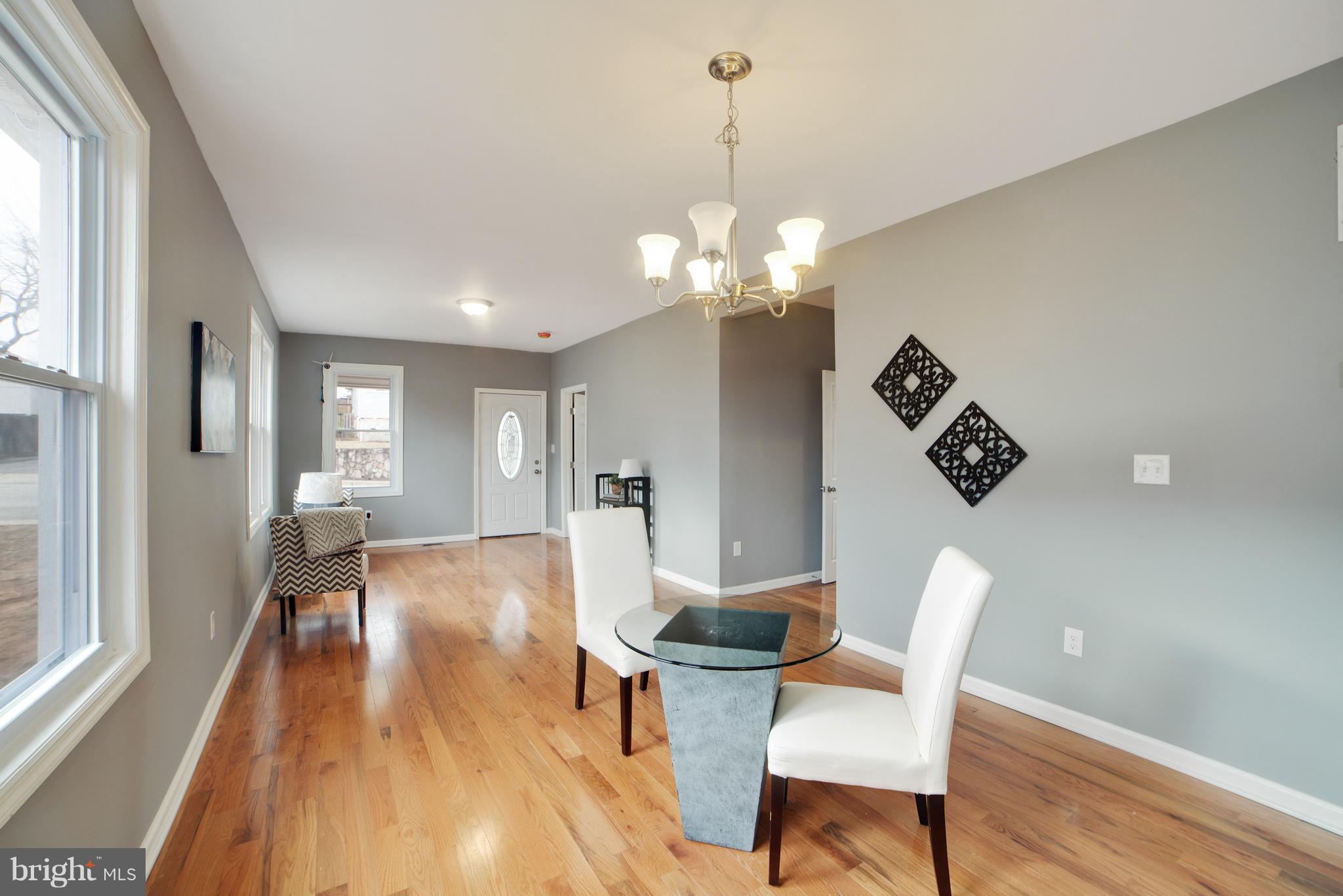 114 West Edgevale Road Baltimore, MD 21225 - Photo 7 of 22 a view of a dining room with furniture wooden floor and chandelier