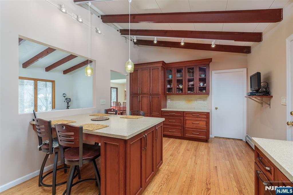12 Ledgewood Terrace Butler, NJ 07405 - Photo 11 of 34 a dining hall with stainless steel appliances kitchen island granite countertop a table and chairs in it