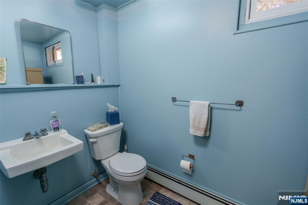 12 Ledgewood Terrace Butler, NJ 07405 - Photo 20 of 34 a bathroom with a sink a toilet and mirror