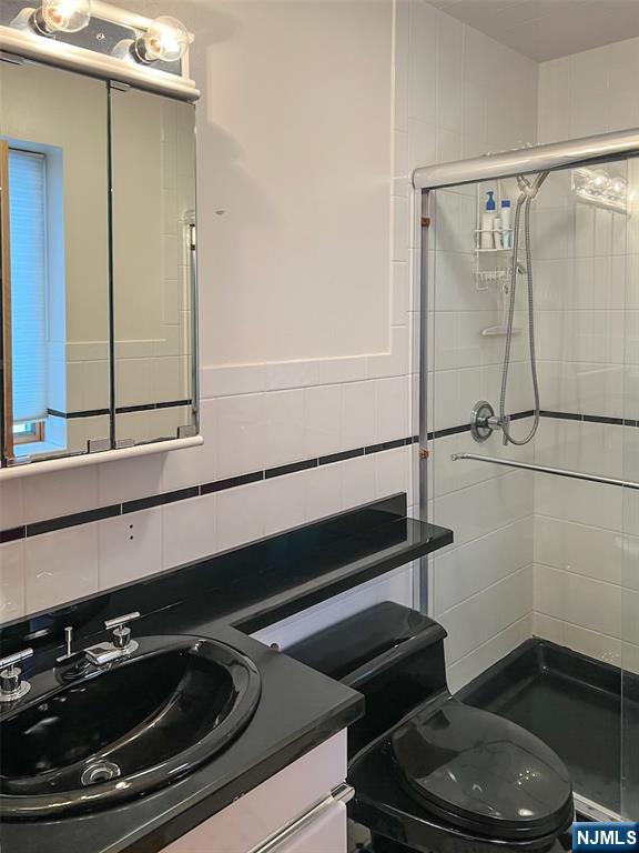 12 Ledgewood Terrace Butler, NJ 07405 - Photo 22 of 34 a bathroom with a sink a toilet and shower