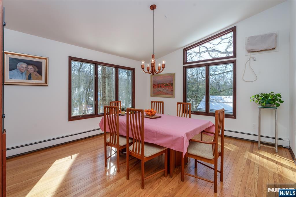 12 Ledgewood Terrace Butler, NJ 07405 - Photo 6 of 34 a dining room with furniture a chandelier and wooden floor