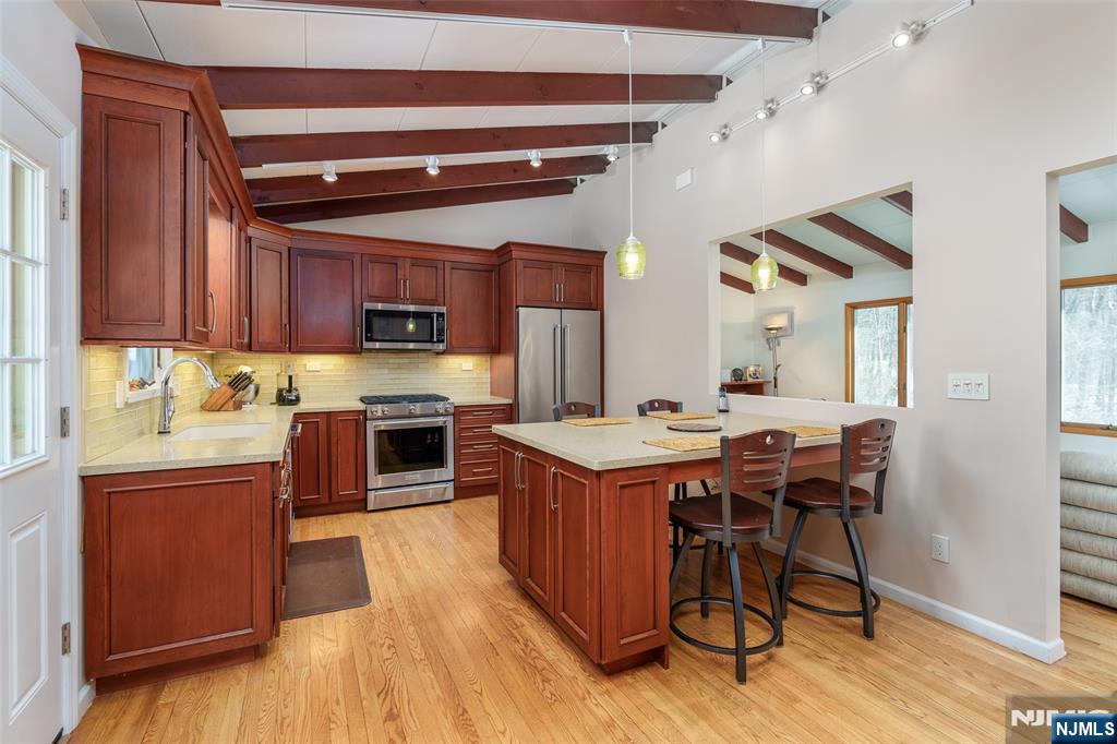 12 Ledgewood Terrace Butler, NJ 07405 - Photo 8 of 34 a kitchen with stainless steel appliances a stove a sink dishwasher and a refrigerator