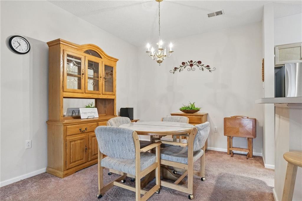 850 Hidden Ridge Court, Unit 101 South Park, PA 15129 - Photo 11 of 38 a view of a dining room with furniture and chandelier