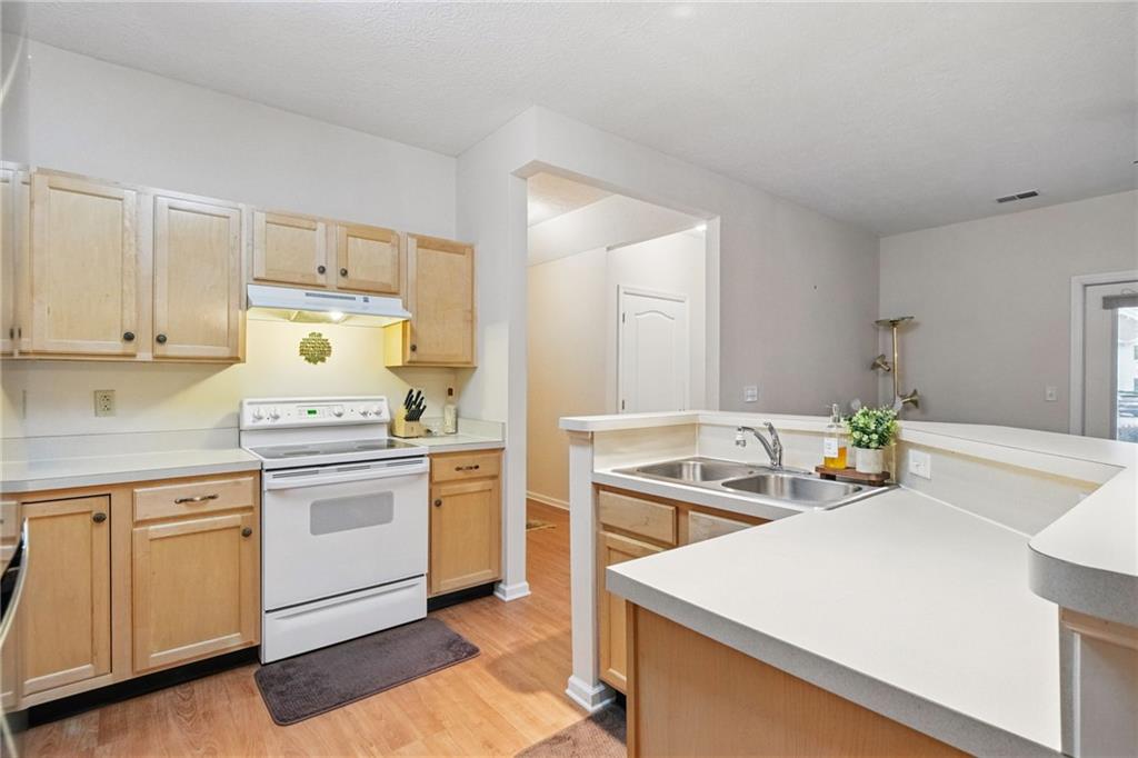 850 Hidden Ridge Court, Unit 101 South Park, PA 15129 - Photo 12 of 38 a kitchen with a stove a sink and a refrigerator