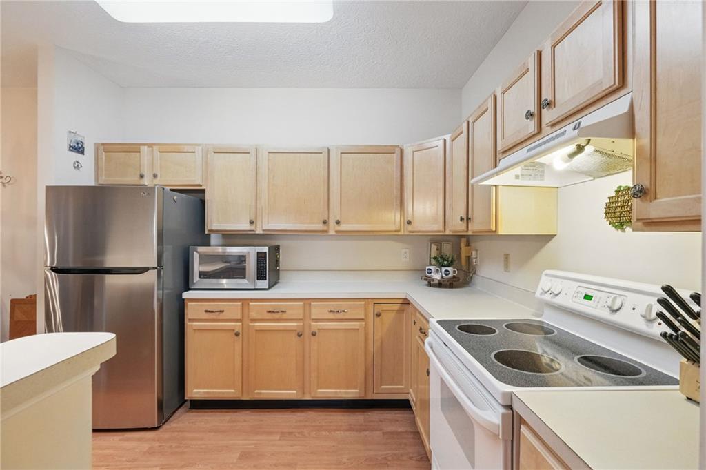 850 Hidden Ridge Court, Unit 101 South Park, PA 15129 - Photo 14 of 38 a kitchen with a sink a refrigerator and cabinets