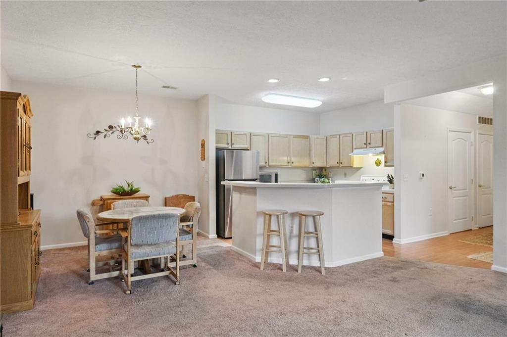 850 Hidden Ridge Court, Unit 101 South Park, PA 15129 - Photo 15 of 38 a view of kitchen with refrigerator dining table and chairs
