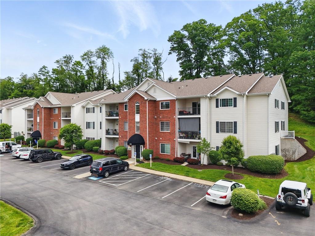 850 Hidden Ridge Court, Unit 101 South Park, PA 15129 - Photo 2 of 38 a front view of a house with a garden and houses