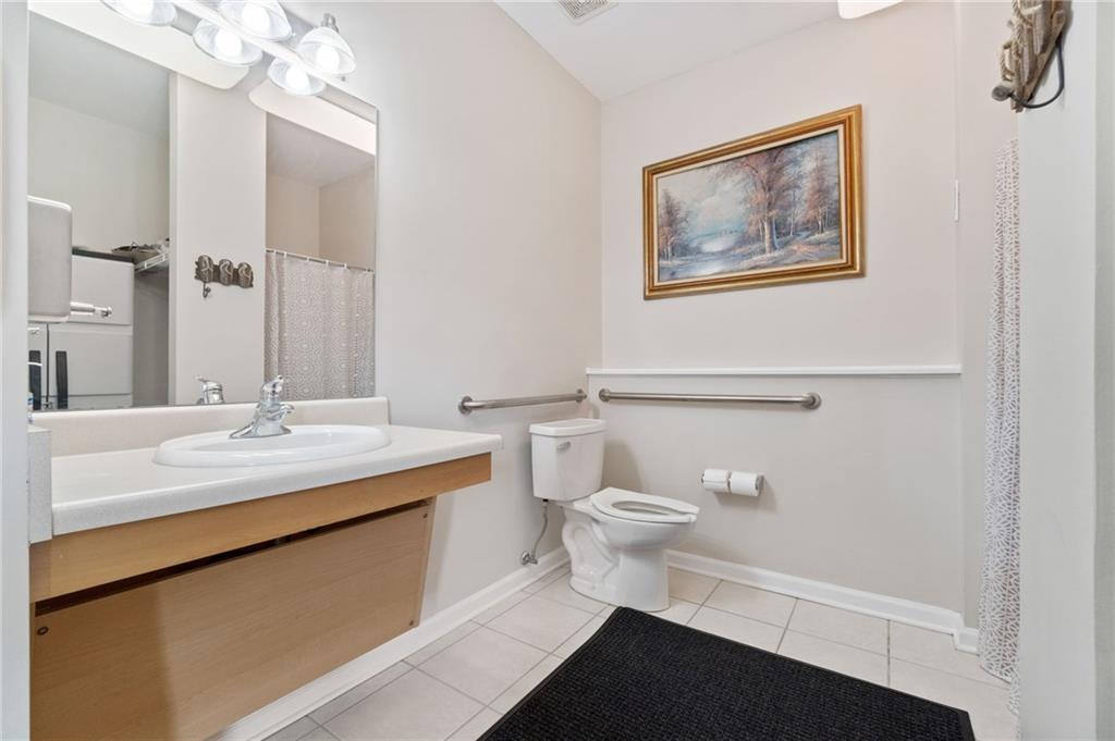 850 Hidden Ridge Court, Unit 101 South Park, PA 15129 - Photo 21 of 38 a bathroom with a sink a toilet and mirror