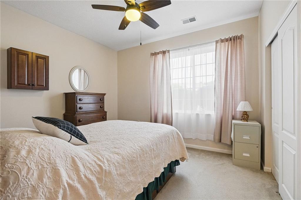 850 Hidden Ridge Court, Unit 101 South Park, PA 15129 - Photo 23 of 38 a bedroom with a bed a window and a chandelier