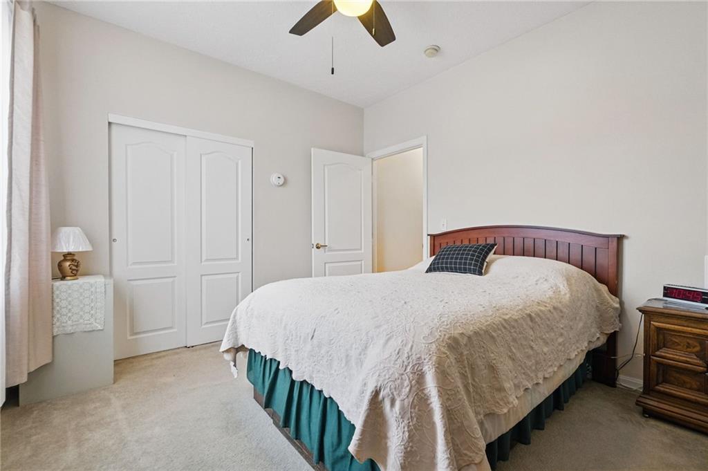 850 Hidden Ridge Court, Unit 101 South Park, PA 15129 - Photo 26 of 38 a bedroom with a bed and a chandelier