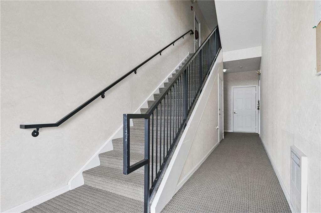 850 Hidden Ridge Court, Unit 101 South Park, PA 15129 - Photo 5 of 38 a view of staircase with wooden floor and white walls