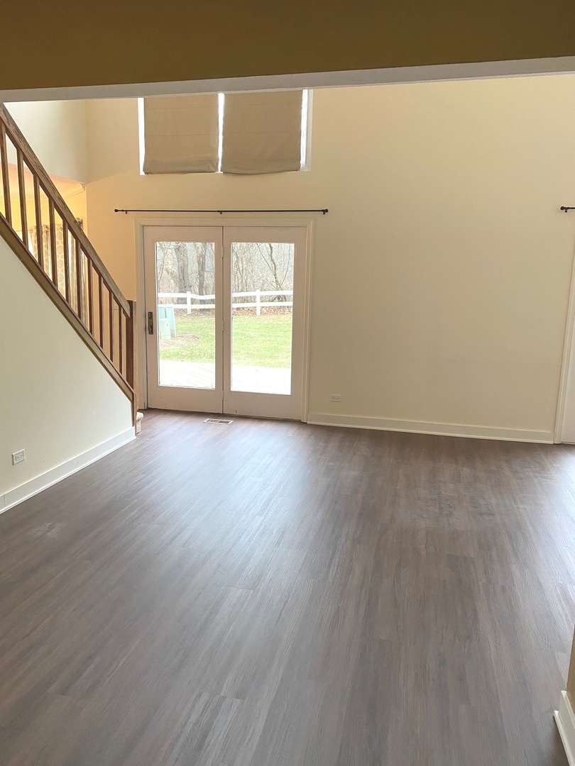 247 Ascot Lane Streamwood, IL 60107 - Photo 11 of 21 a view of an empty room with wooden floor and a window