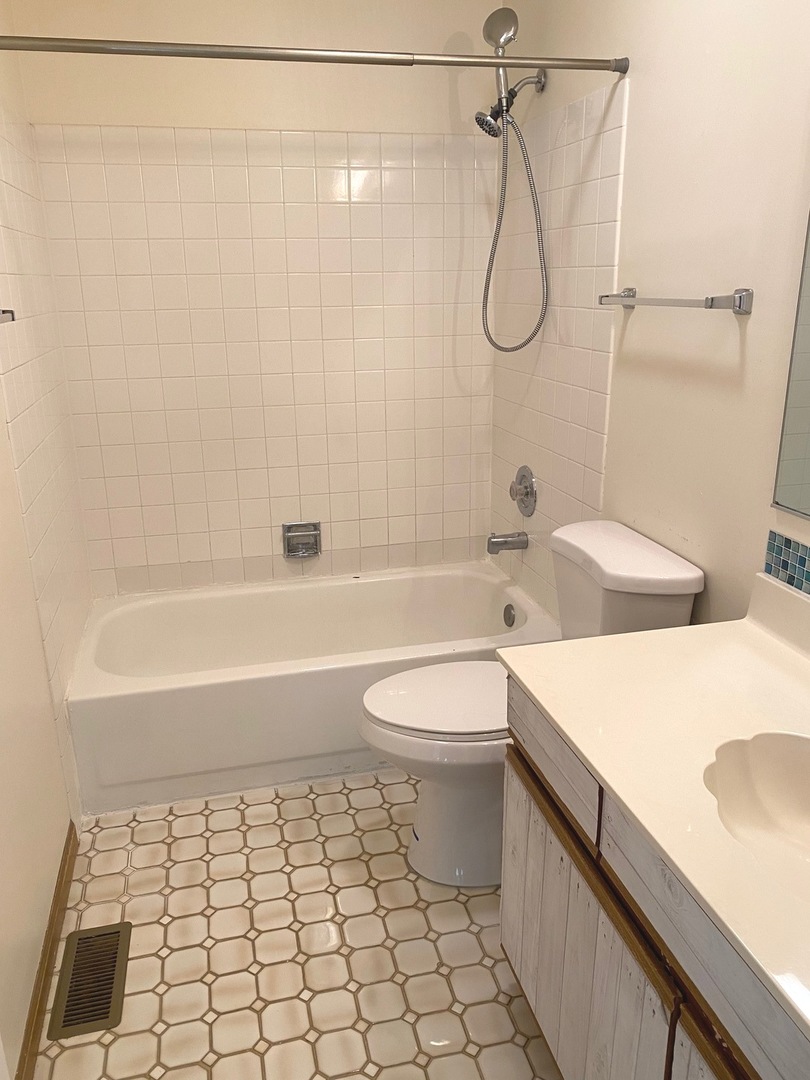 247 Ascot Lane Streamwood, IL 60107 - Photo 18 of 21 a bathroom with a granite countertop sink a toilet and shower