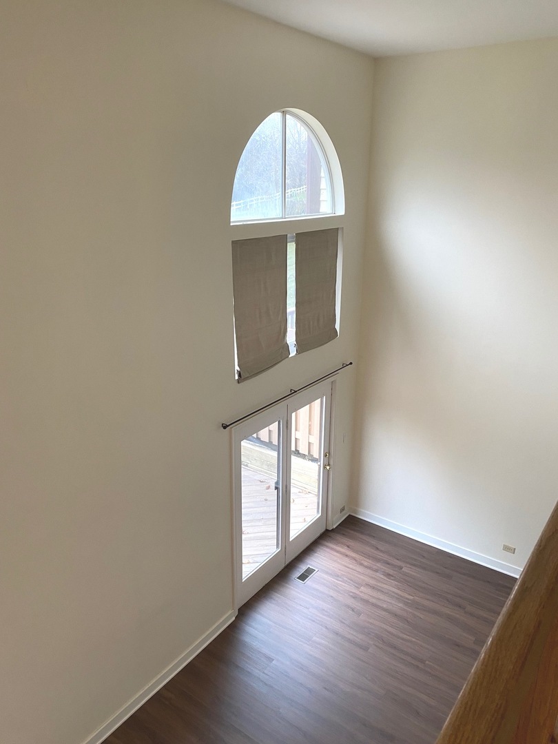 247 Ascot Lane Streamwood, IL 60107 - Photo 20 of 21 an empty room with wooden floor cabinet and window