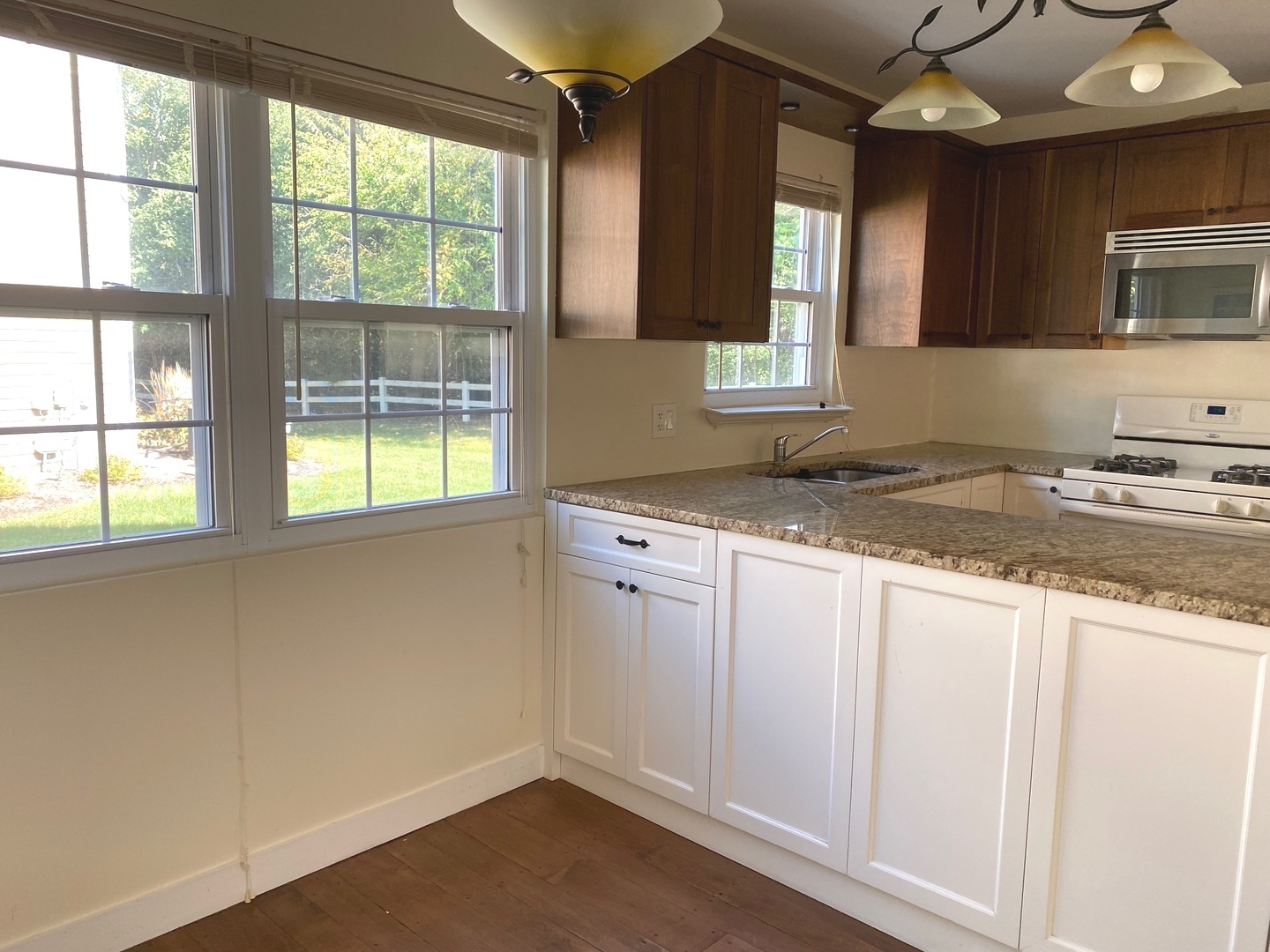 247 Ascot Lane Streamwood, IL 60107 - Photo 3 of 21 a kitchen with a sink window and cabinets