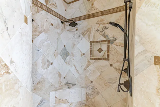 a bathroom with a granite countertop sink toilet a mirror and shower