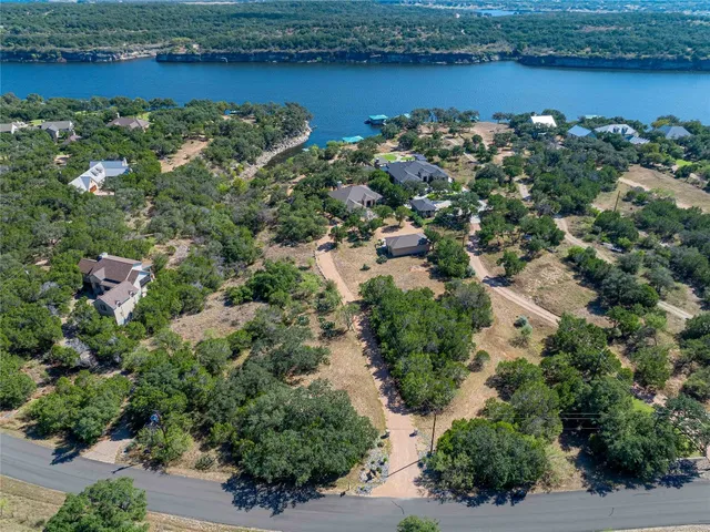 an aerial view of a houses with outdoor space and lake view