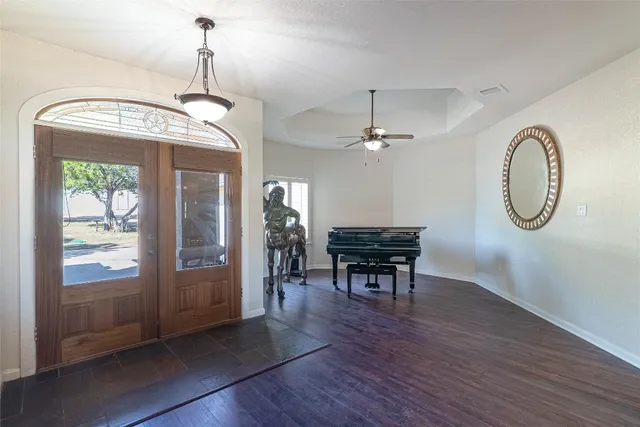 a kitchen with kitchen island granite countertop a sink cabinets and refrigerator