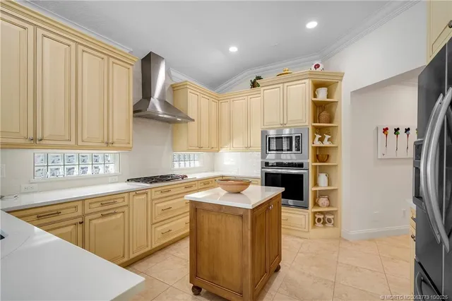a kitchen with stainless steel appliances a refrigerator stove and cabinets