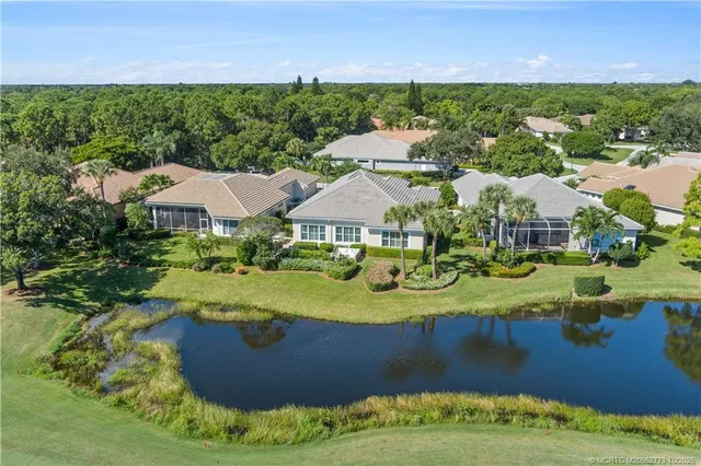 an aerial view of a house with garden view and a lake view