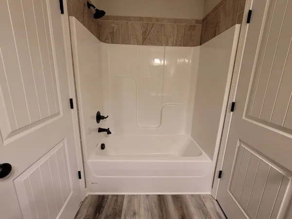 a bathroom with a bathtub and a shower