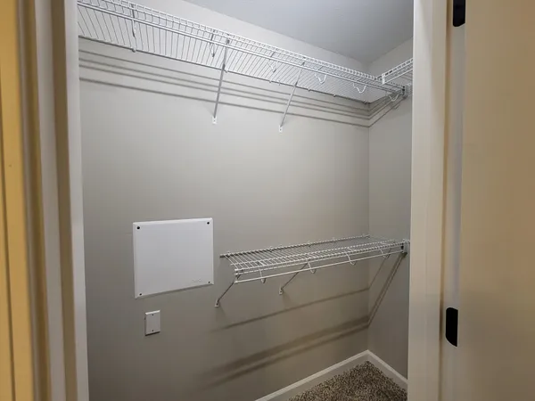 a view of storage and utility room with racks on the wall