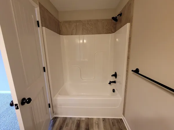 a bathroom with a bathtub and a shower