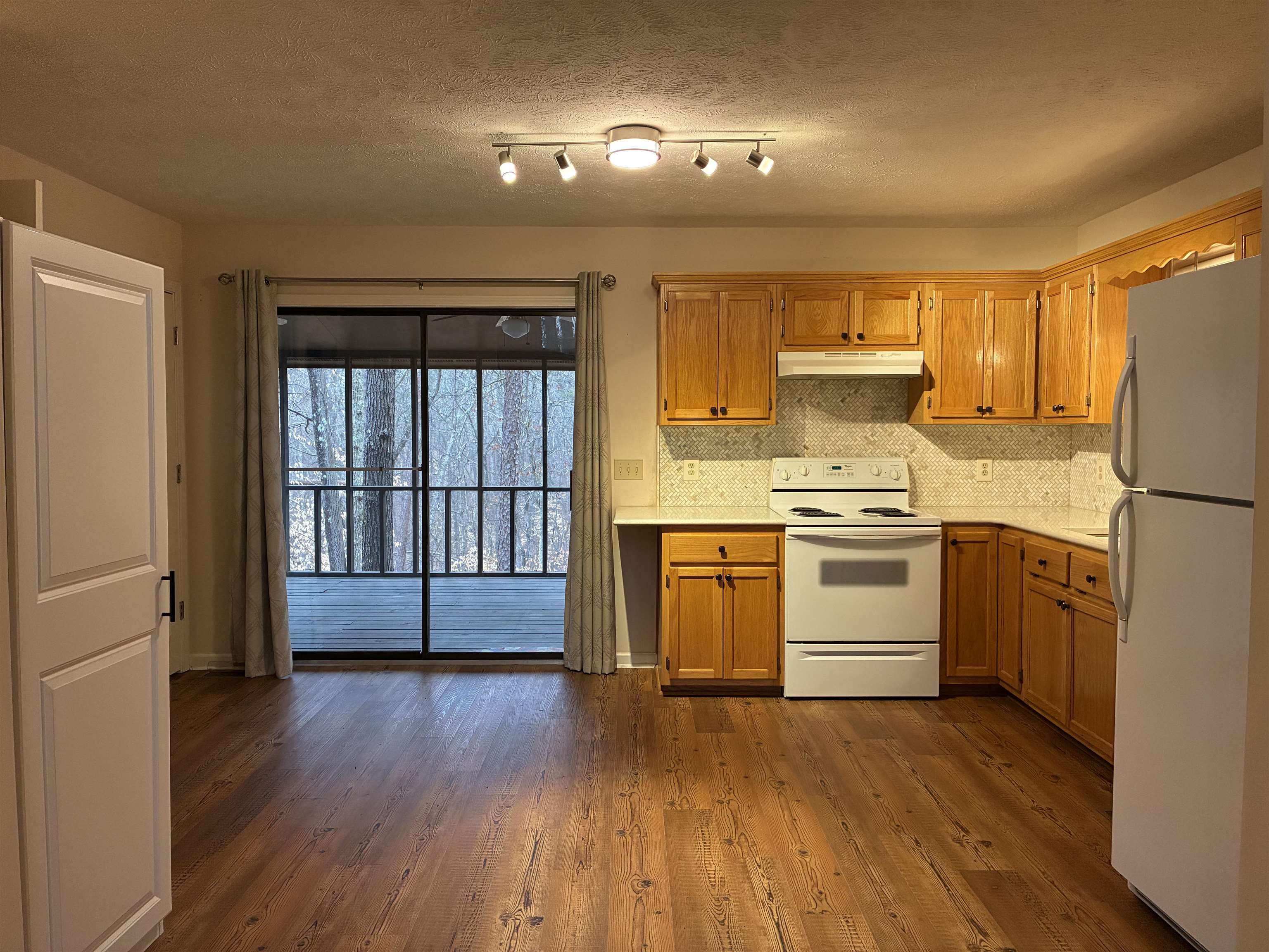 54 Whispering Lane Counce, TN 38326 - Photo 11 of 35 a kitchen with a wooden floor and a window