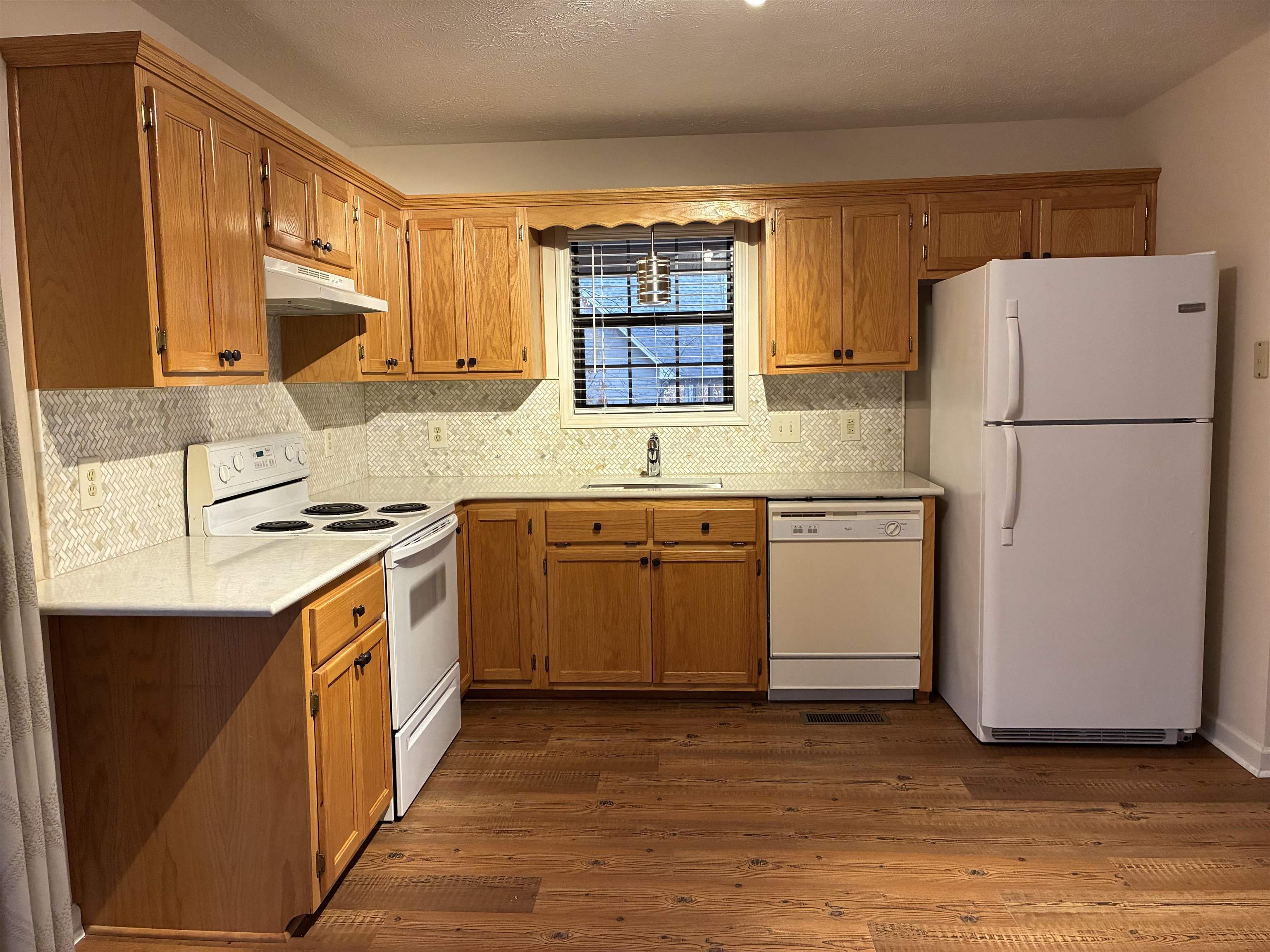 54 Whispering Lane Counce, TN 38326 - Photo 12 of 35 a kitchen with a sink a window a refrigerator and a stove