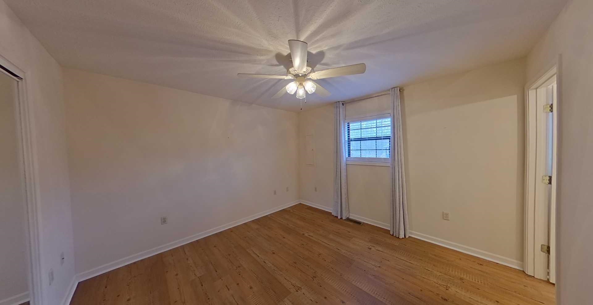 54 Whispering Lane Counce, TN 38326 - Photo 19 of 35 an empty room with windows and fan
