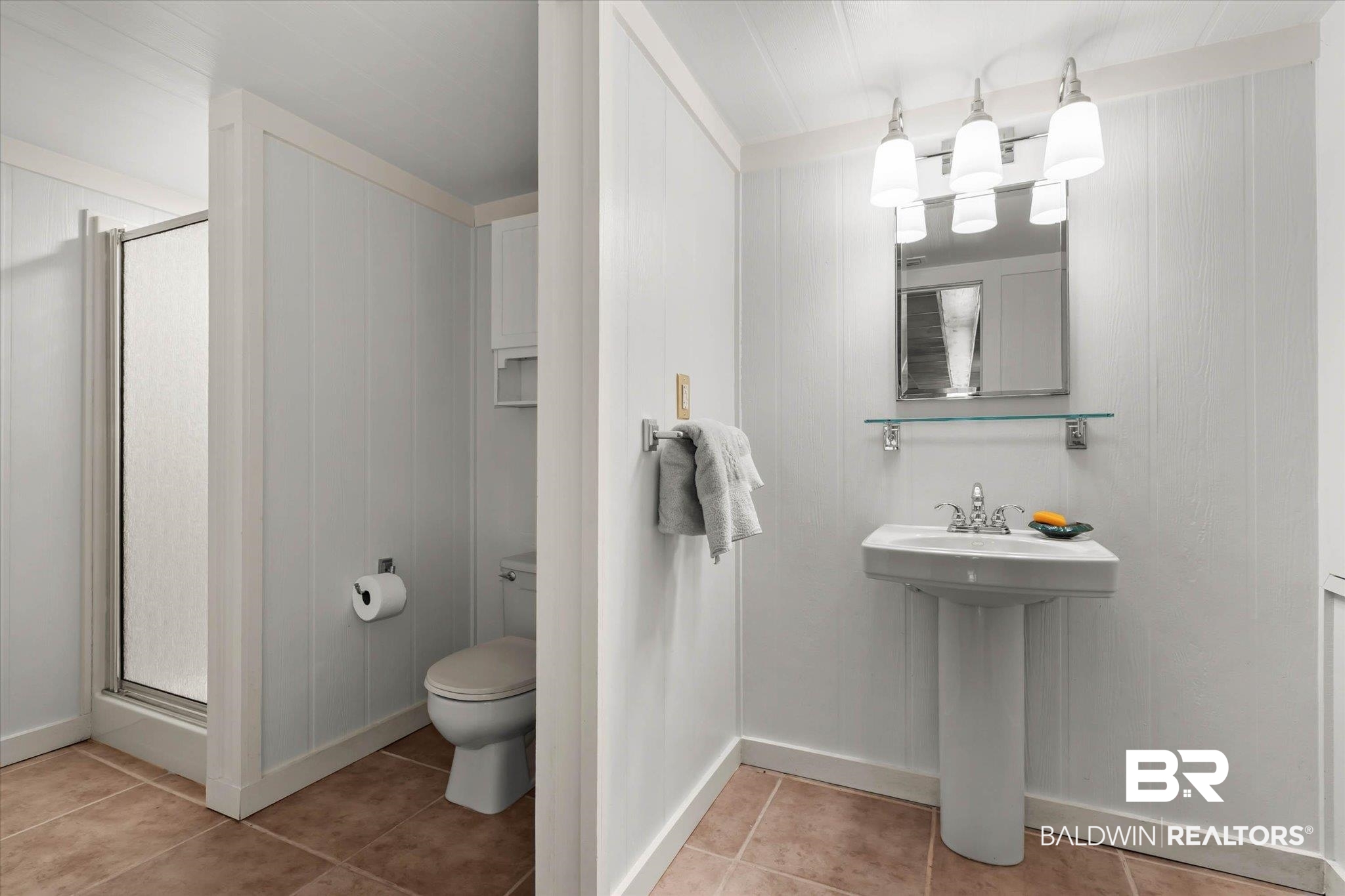 3500 Venetia Road Mobile, AL 36605 - Photo 33 of 56 Bathroom featuring a pedestal sink with chrome fixtures, a wall-mounted mirror, and a three-light vanity fixture