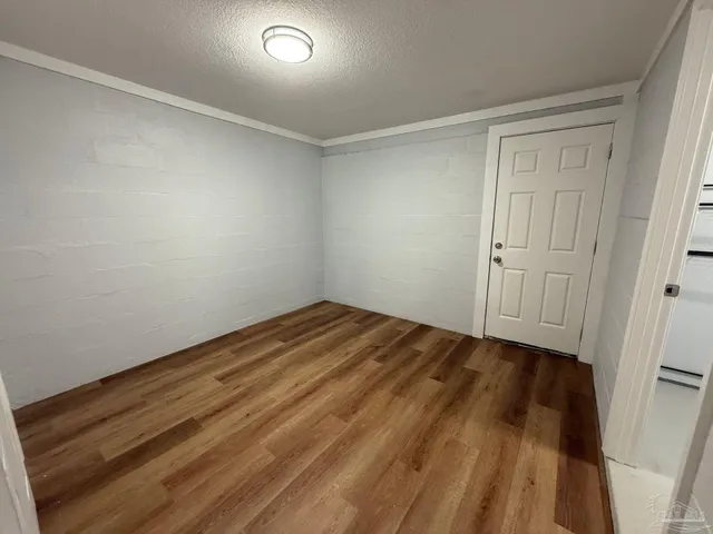 a view of a room with wooden floor and closet