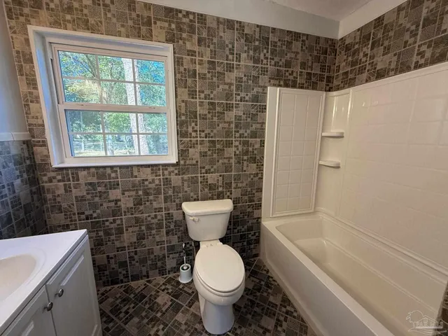 a bathroom with a toilet a sink and bathtub