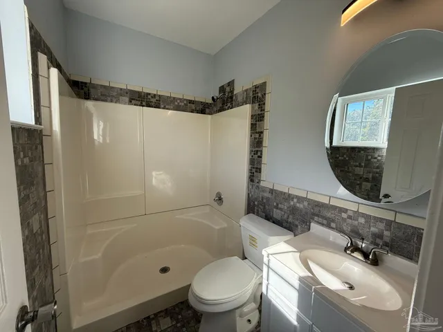 a view of a room with wooden floor and fan