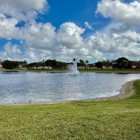 a view of a lake with houses in the back